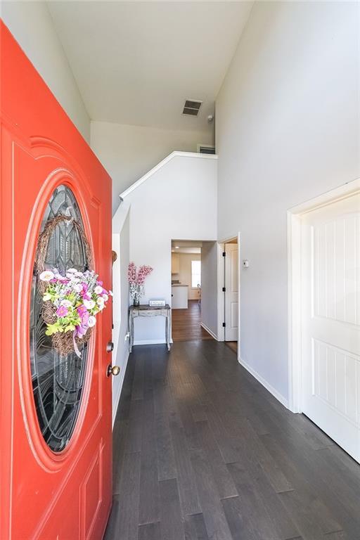 entrance foyer featuring a high ceiling and dark hardwood / wood-style flooring