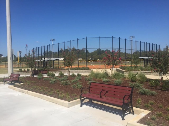 view of home's community featuring fence