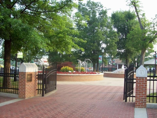view of home's community featuring fence and a gate