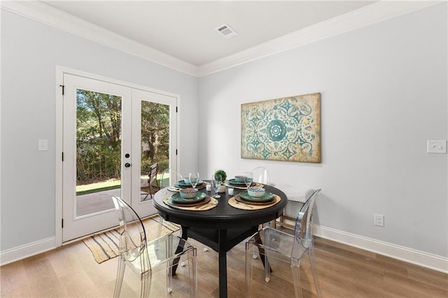 dining room with french doors, hardwood / wood-style flooring, and a healthy amount of sunlight