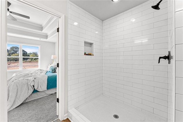 bathroom featuring a tile shower, ornamental molding, and ceiling fan