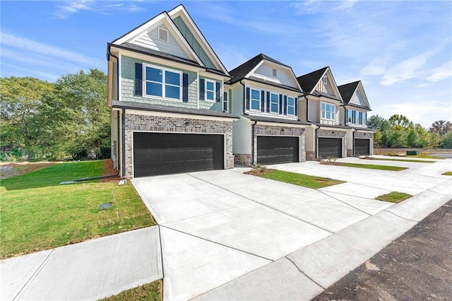 view of front of house with a garage and a front lawn