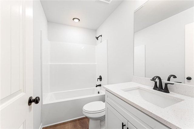 full bathroom with vanity, hardwood / wood-style flooring, toilet, and shower / bathtub combination