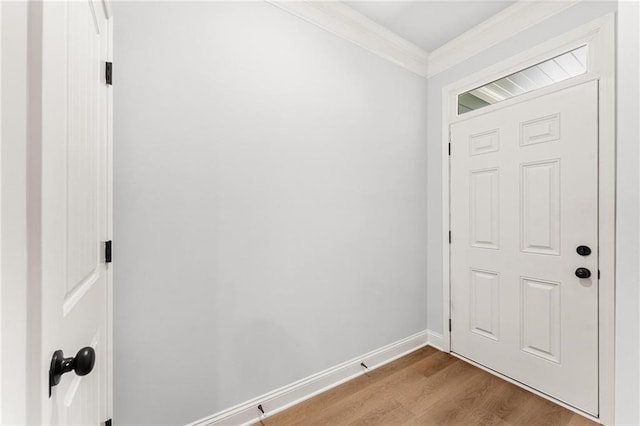 entrance foyer with light hardwood / wood-style floors and crown molding