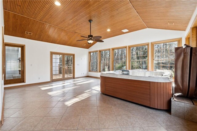 unfurnished sunroom with ceiling fan, a healthy amount of sunlight, wood ceiling, and french doors