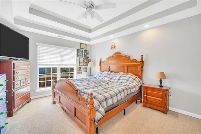 bedroom with visible vents, a tray ceiling, carpet flooring, crown molding, and baseboards