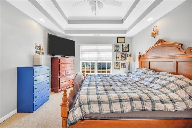 bedroom with crown molding, a raised ceiling, and carpet