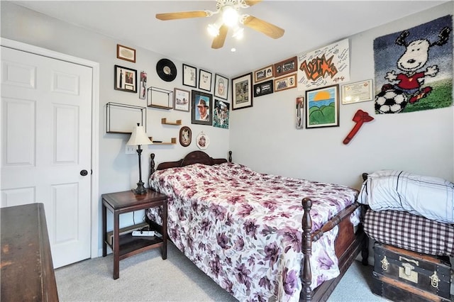 bedroom with a ceiling fan and light colored carpet