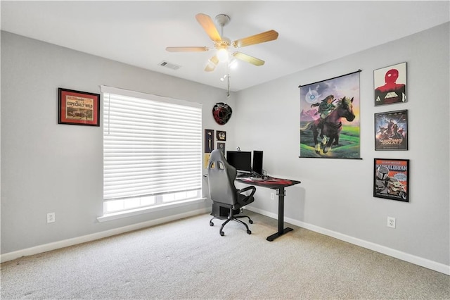 carpeted office featuring a ceiling fan, baseboards, and visible vents