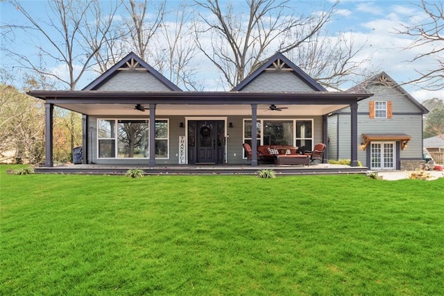 back of house with an outdoor hangout area, ceiling fan, and a lawn