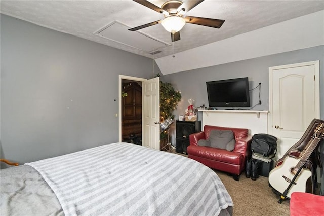 bedroom with a textured ceiling, ceiling fan, carpet floors, and lofted ceiling