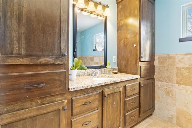 bathroom with vanity and tile walls