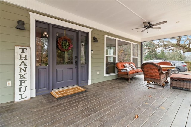 entrance to property with ceiling fan and covered porch