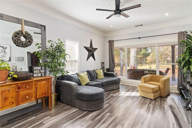 living room with ceiling fan, ornamental molding, and hardwood / wood-style flooring