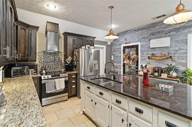 kitchen with wall chimney exhaust hood, dark brown cabinets, wood walls, and stainless steel appliances