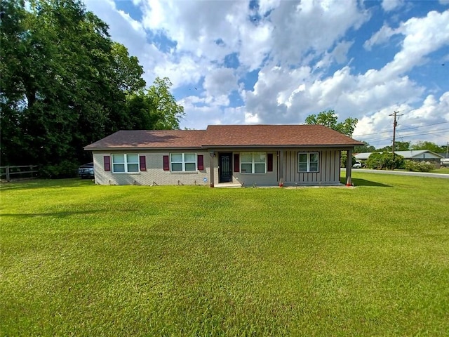 view of front of home featuring board and batten siding and a front yard