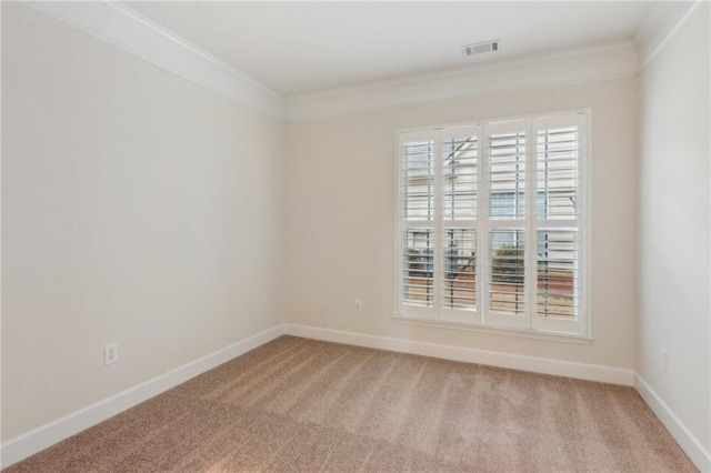 unfurnished room with visible vents, baseboards, light colored carpet, and crown molding