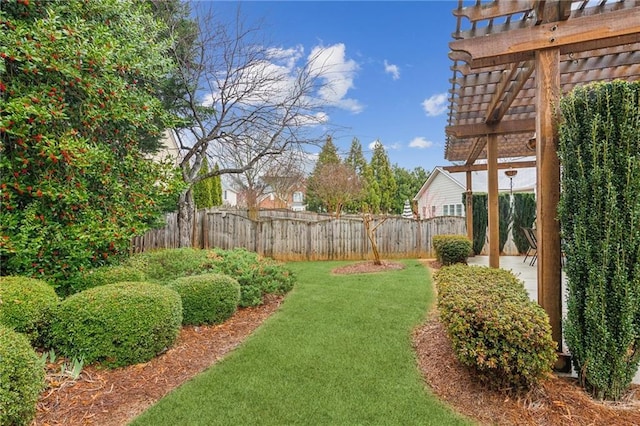 view of yard with fence and a pergola