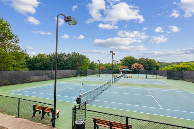 view of tennis court with fence