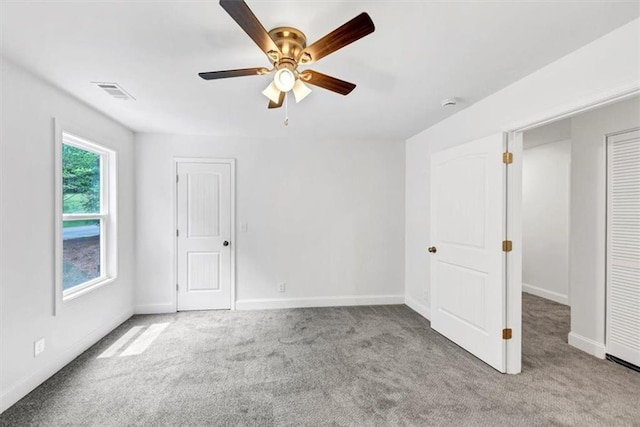 unfurnished bedroom featuring carpet flooring, baseboards, and visible vents