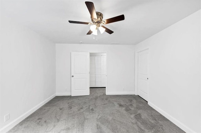 unfurnished bedroom featuring carpet floors, baseboards, and ceiling fan