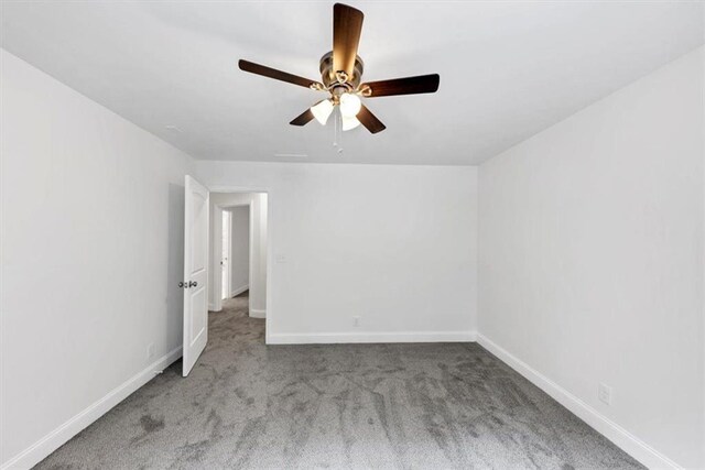 unfurnished bedroom featuring carpet floors and baseboards