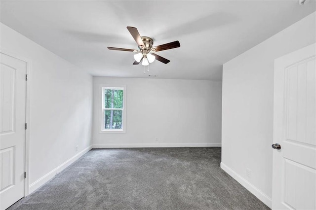 carpeted empty room featuring ceiling fan and baseboards