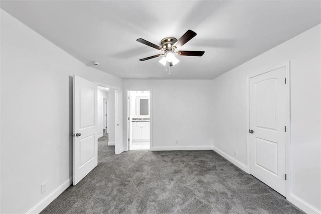 unfurnished bedroom with baseboards, carpet flooring, and connected bathroom