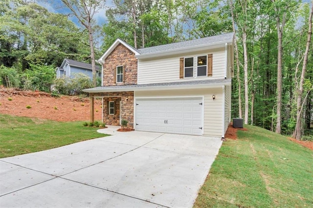 traditional-style house with concrete driveway, a front yard, stone siding, and a garage