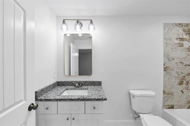 full bath featuring vanity, baseboards, and toilet