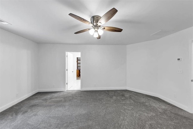 carpeted empty room featuring a ceiling fan and baseboards