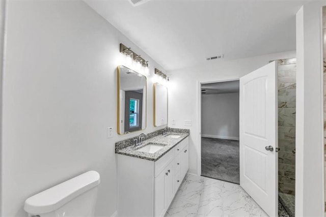 full bathroom with a sink, toilet, double vanity, and marble finish floor