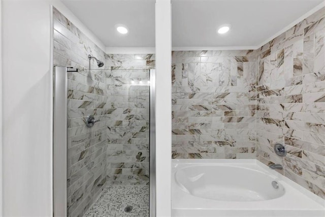 bathroom with a bathing tub, a tile shower, and recessed lighting