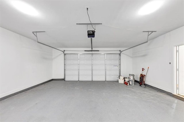 garage with baseboards and a garage door opener