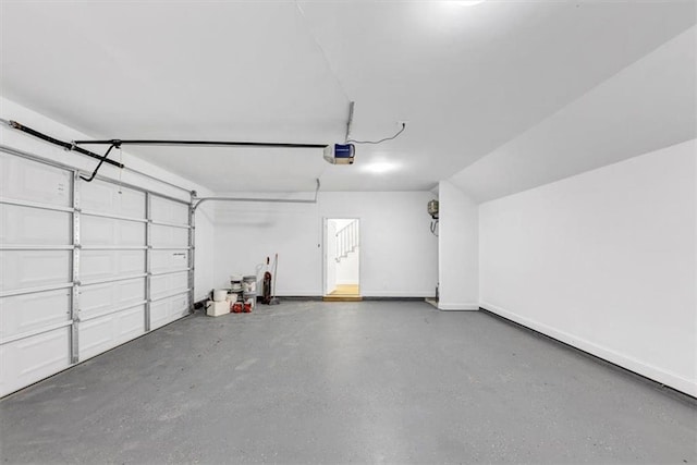 garage with baseboards and a garage door opener