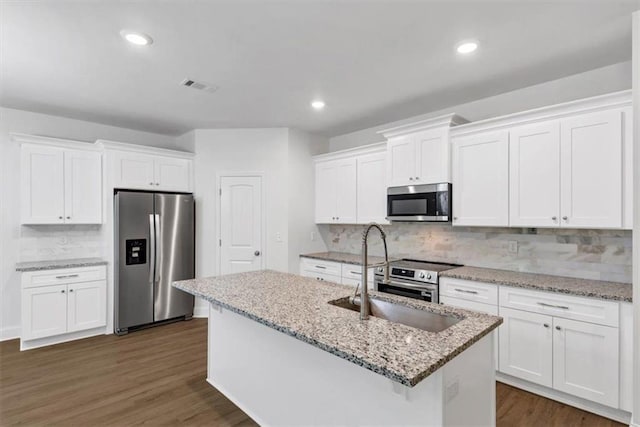 kitchen with white cabinetry, appliances with stainless steel finishes, a sink, and visible vents