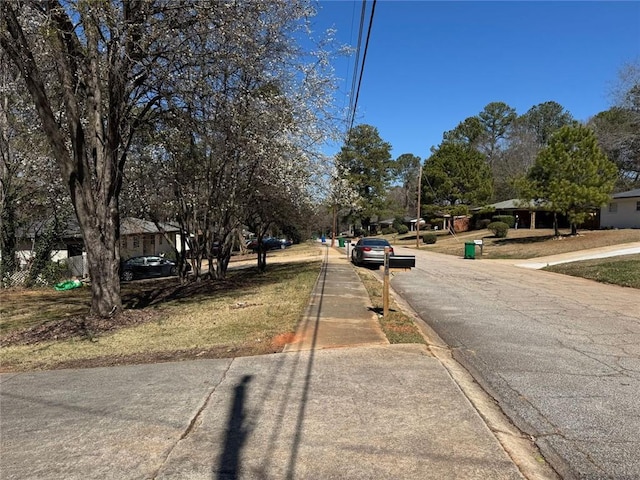 view of road with sidewalks and curbs