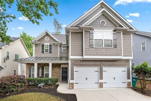craftsman house featuring concrete driveway, a standing seam roof, a garage, stone siding, and metal roof