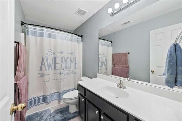 bathroom with toilet, vanity, shower / bath combo with shower curtain, and tile patterned flooring