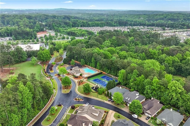 view of property location with a heavily wooded area