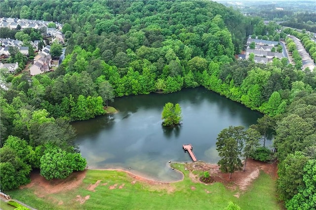 aerial view of property and surrounding area featuring a nearby body of water and nearby suburban area