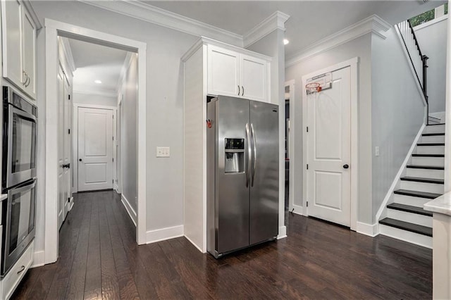 647 E Ave NE, Atlanta, GA 30312 - kitchen with white cabinets, crown molding, stainless steel appliances, baseboards, and dark wood-type flooring