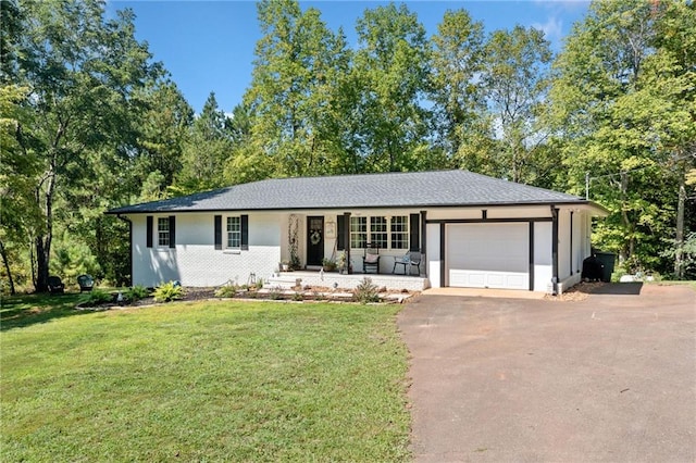 ranch-style house featuring a front yard and a garage