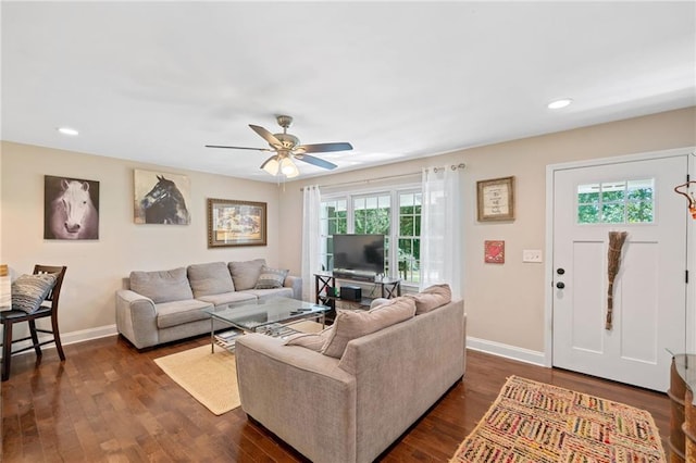 living room with ceiling fan and dark hardwood / wood-style floors