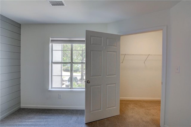 3263 Long Iron Pl, Lawrenceville, GA 30044 - unfurnished bedroom featuring a walk in closet, carpet flooring, a closet, and baseboards