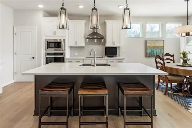 15 Lakeside Way, Cartersville, GA 30121 - kitchen featuring appliances with stainless steel finishes, a sink, a breakfast bar, white cabinets, and recessed lighting