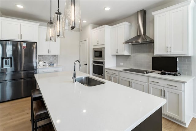 15 Lakeside Way, Cartersville, GA 30121 - kitchen with appliances with stainless steel finishes, wall chimney range hood, a sink, an island with sink, and decorative backsplash