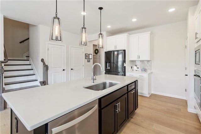 15 Lakeside Way, Cartersville, GA 30121 - kitchen featuring stainless steel appliances, a sink, a kitchen island with sink, light wood-style floors, and white cabinetry