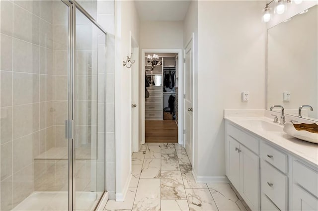 15 Lakeside Way, Cartersville, GA 30121 - bathroom featuring marble look tiles, vanity, a stall shower, and a spacious closet