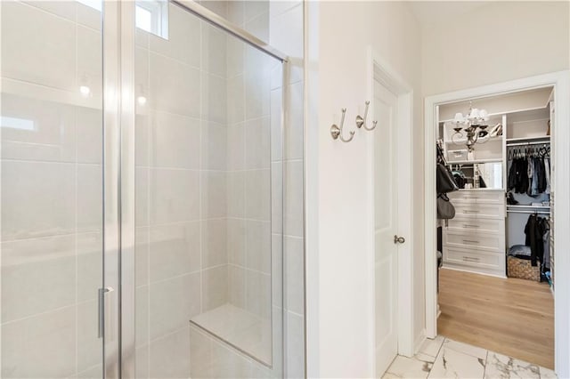 15 Lakeside Way, Cartersville, GA 30121 - full bathroom featuring a shower stall, a walk in closet, a chandelier, and marble finish floors